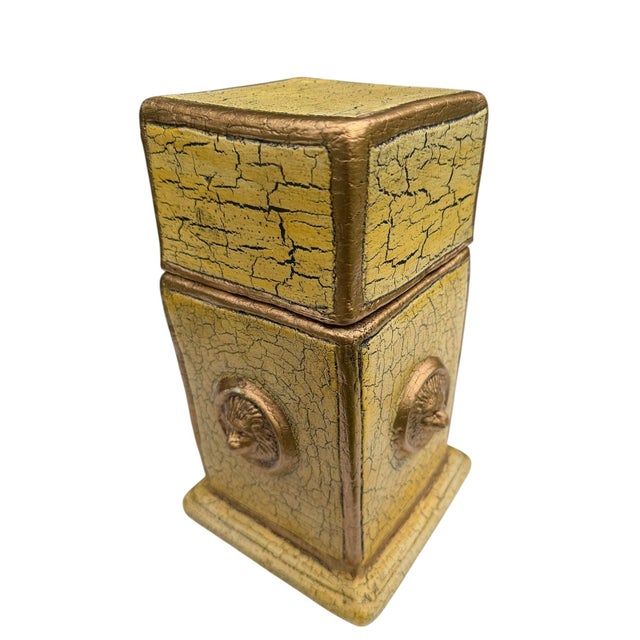 A vintage handcrafted terracotta covered urn featuring an antiqued crackle-painted finish with gilt accents and raised...
