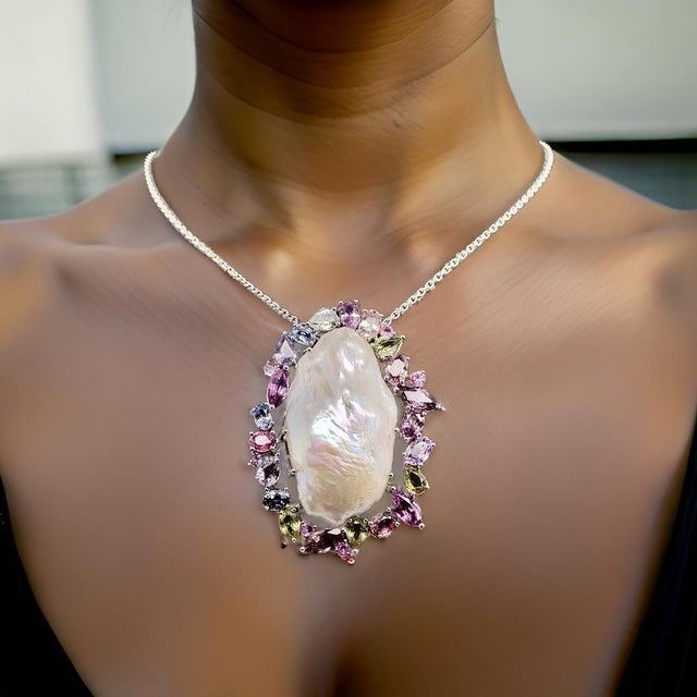 Custom made, Sapphire and Baroque Pearl Necklace set in 14 Kt white gold with 5 CTS of sapphires surrounding the large...