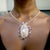 Custom made, Sapphire and Baroque Pearl Necklace set in 14 Kt white gold with 5 CTS of sapphires surrounding the large...