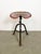 Vintage industrial three-legged height adjustable swivel chair from the 1950s. An old tractor seat mounted on an iron...
