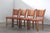 Four vintage Danish dining chairs, crafted in the 1960s-1970s in the style of designer Henning Kjærnulf. These chairs...