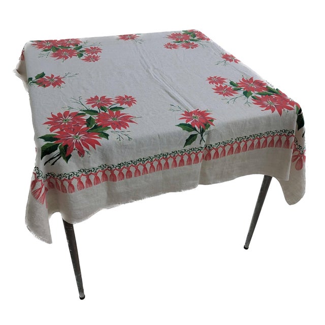 Offered is a mid 20th Century vintage cream-colored linen cotton Christmas motif tablecloth featuring a red poinsettia...