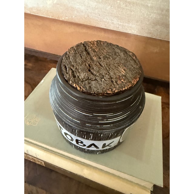 A charming mid-century pottery tobacco jar marked “TOBAK,” likely of Italian origin, featuring a wonderfully textured...