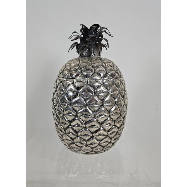 A large sculptural Italian mid-century ice bucket in the form of a pineapple, executed in silver-plated metal with a...