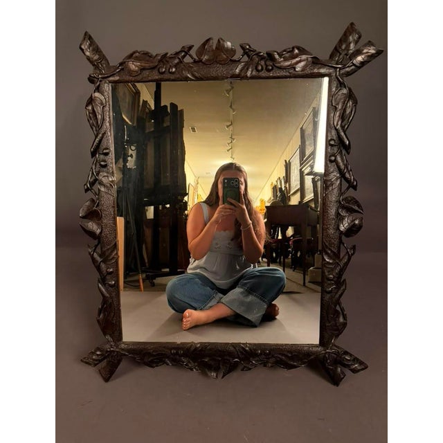 Beautiful European-style hand-carved mirror dating to circa 1900, featuring an intricate faux bois motif accented with...