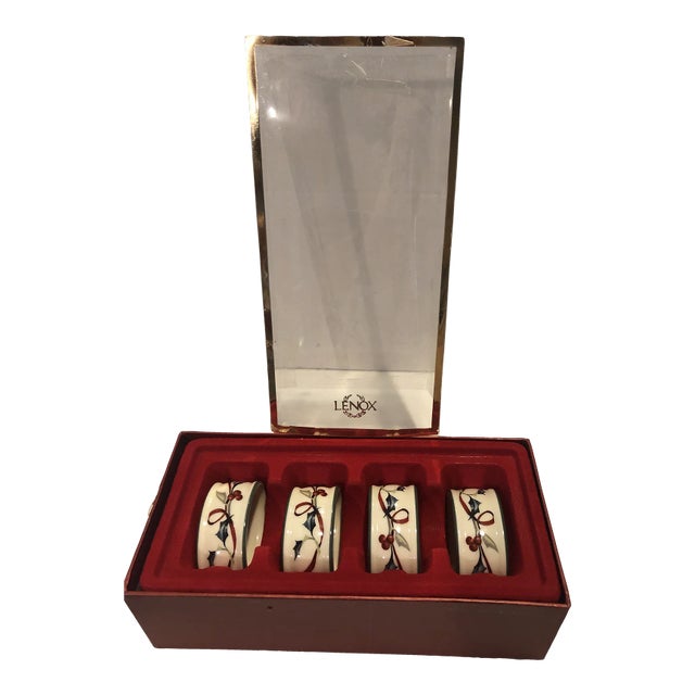 Lovely set of 4 Lenox “Winter Greetings” porcelain napkins rings , new in box . Holly & ribbons, Excellent condition .