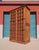 A substantial vintage Mexican solid wood armoire featuring exceptional architectural character and handcrafted detailing....