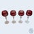 This stunning set of four mid-century wine glasses features rich cranberry cut-to-clear bowls etched with a classic...