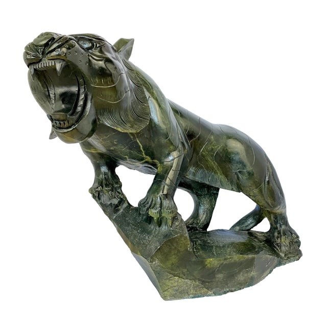 An impressive monumental hand-carved Chinese tiger sculpted from a single block of richly colored spinach green nephrite...