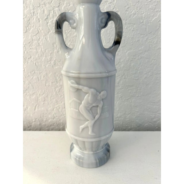 Vintage Jim Beam blue and gray swirl slag glass decanter featuring an embossed image of a male Grecian discus thrower with...