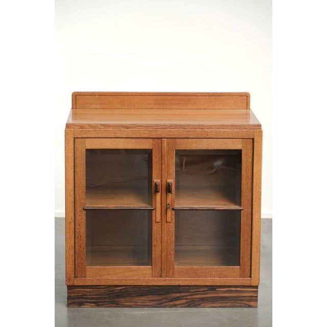 This charming, understated Dutch oak Amsterdam School cabinet—or Art Deco cabinet—dates from the early 20th century and...