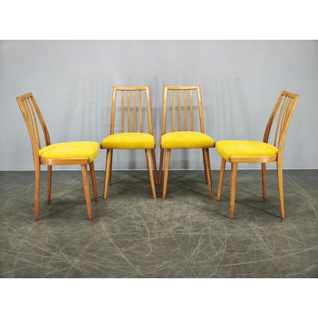 Elegant set of four mid-century modern dining chairs manufactured by ton in czechoslovakia during the 1970s. The chairs...