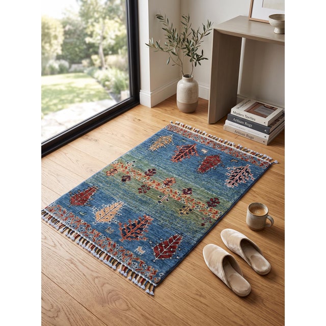 This small hand-knotted Gabbeh rug was woven in Afghanistan by Turkmen weaving families in the pictorial folk style of the...