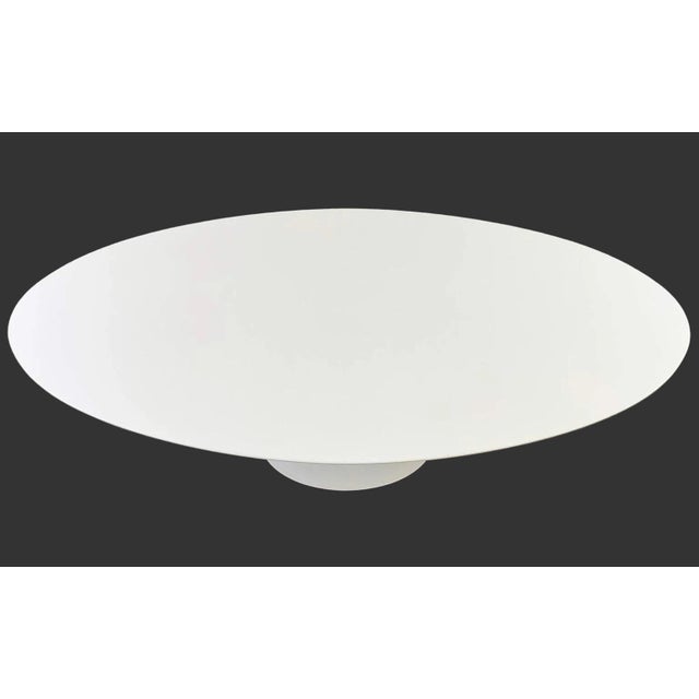 The authentic Eero Saarinen Pedestal or Tulip Oval Dining Table for Knoll Studio, was designed to "clear the slum under...