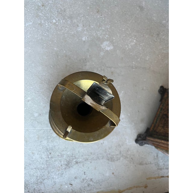 unusual antique cigarette stand. the base twists off from the column in order to empty the ashes and cigarette butts....