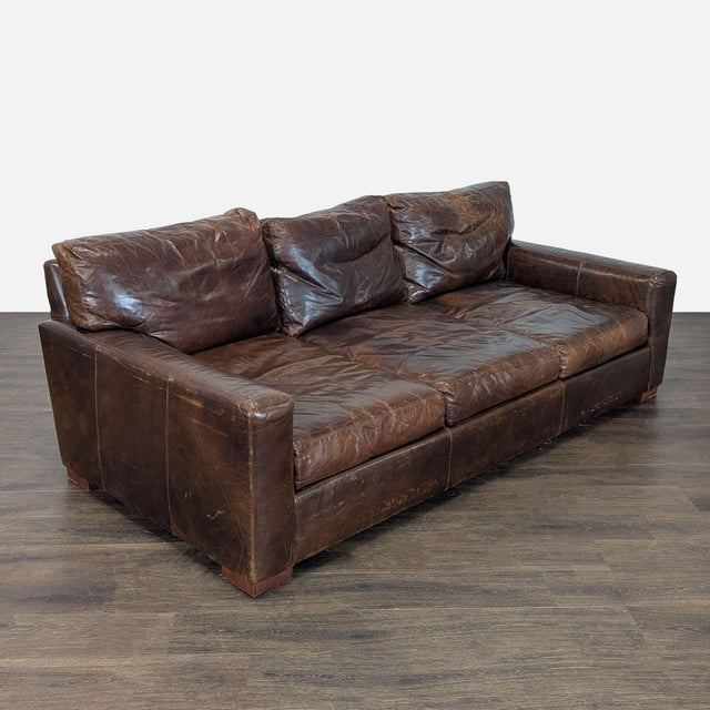 This Restoration Hardware 3-seat sofa features rich brown leather and spacious seating. The sofa has a sturdy frame and...