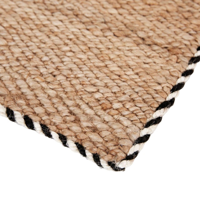 Hand-woven in natural jute and accented with a contrasting, twisted border, this durable mat adds texture and character to...