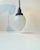 A 1930s ceiling light composed of a black bakelite top and set with a drop shaped shade in opaque partially cut crystal...