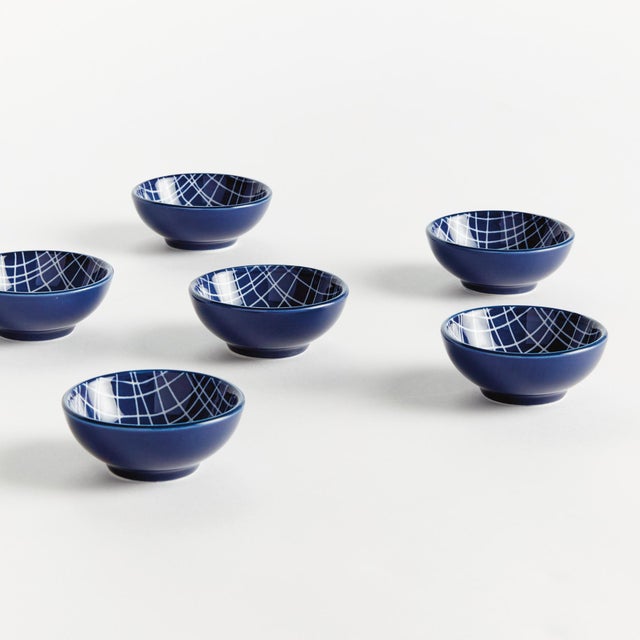 Set the table with a composition in blue. This little stoneware dip bowl set with modern striated design is also perfect...