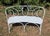 Curved wrought iron bench, lacquered white, backrest decorated with wrought iron scrolls, seat made of thick iron plates...