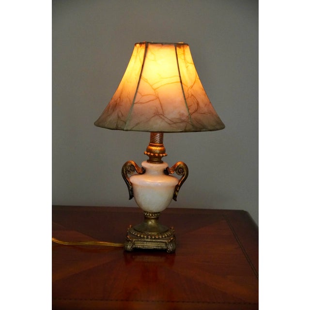 This vintage petite French-style accent lamp is crafted with a polished alabaster urn-form body and adorned with gilt...