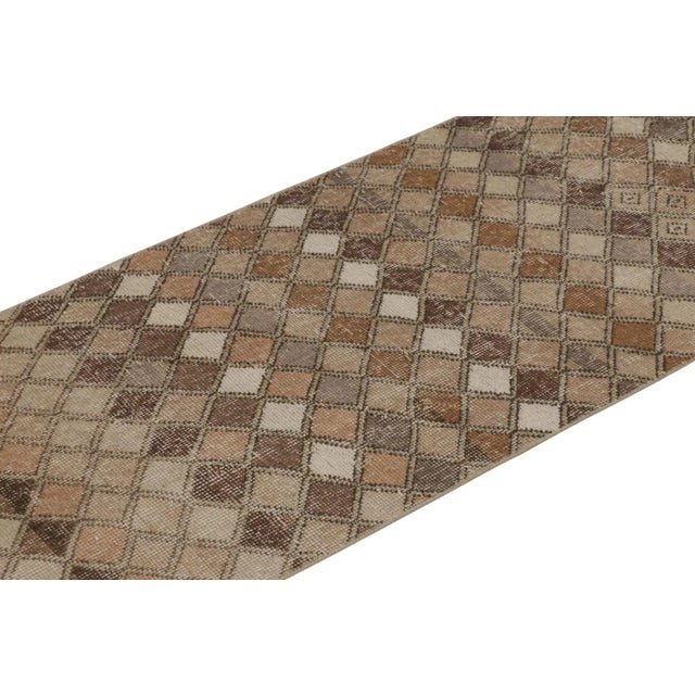 This vintage runner rug is a 2x7 Turkish distressed piece, made with hand-knotted wool circa mid-20th century. It is an...