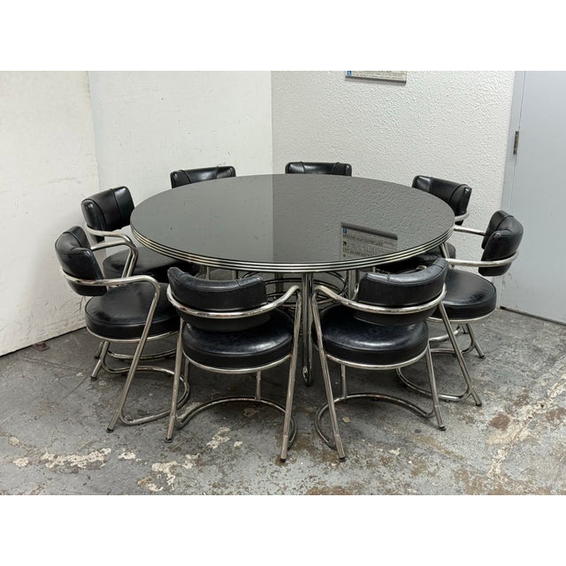 Design Plus Gallery presents a Late 20th Century Table + Set of Eight Chairs. The set has a round table with eight...