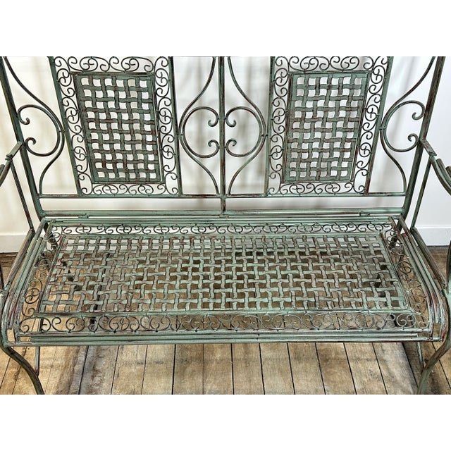 Patinated green folding iron garden bench decorated with crosspieces. size 120 x 48 cm Height 100cm Seat height 45 cm