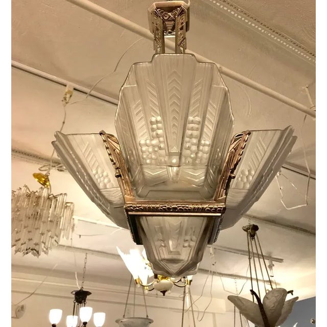 Stunning French Art Deco chandelier signed by E.J.G. having four clear frosted glass panels with center shade having...