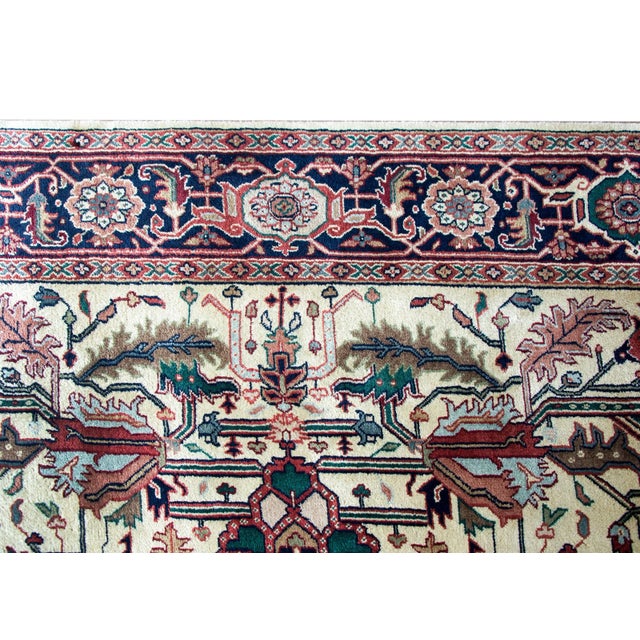 A beautiful vintage Indian Heriz-style rug with a large-scale all-over mirrored stylized floral and leaf pattern woven in...