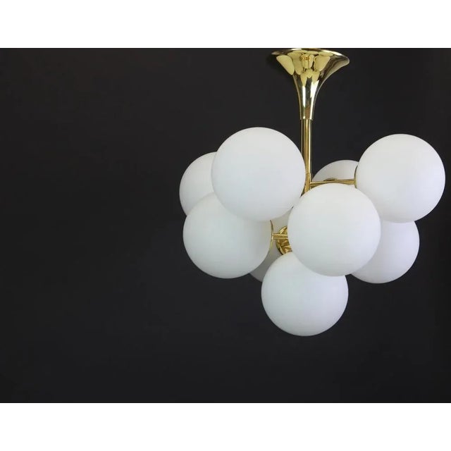 Atomic brass chandelier with nine-glass globes. The globes are hand blown and fitted with a screwing device. High quality...