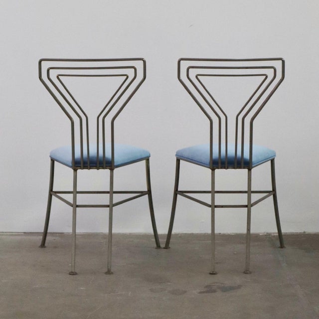 matching pair of 1950s martini chairs with sculptural metal frames and newly upholstered blue velvet seats. both chairs...
