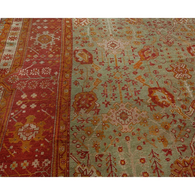 Effortless beauty and soft distinguishes this hand-knotted wool antique Turkish Oushak area rug dating back to 1910. It...
