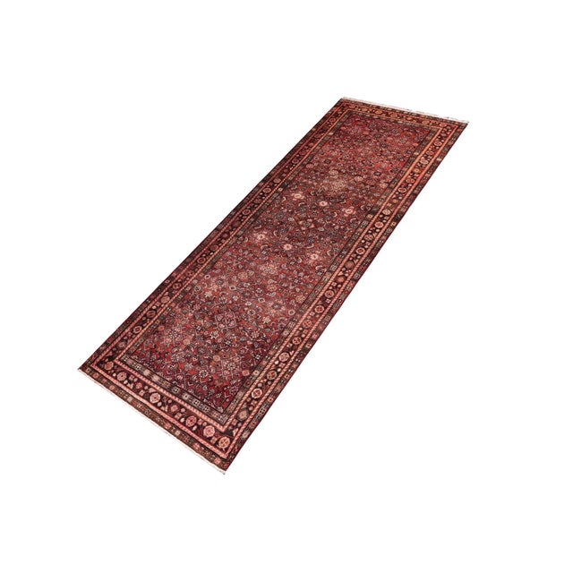 This Persian Tabriz runner is a vintage antique-inspired, hand knotted wool piece in red and brown, crafted by skilled...