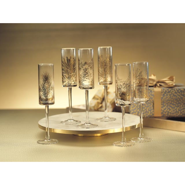 This set of Festivity Champagne Flutes is perfect for chic holiday celebrations. Made from clear glass with gold botanical...