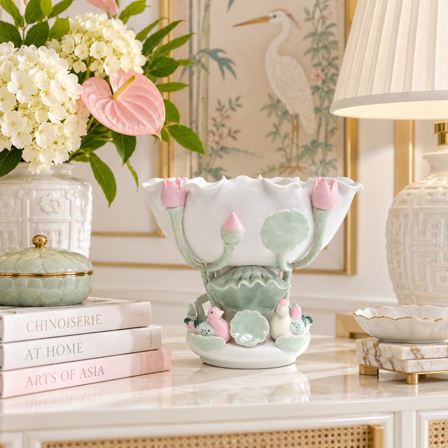 This is a rare and unusual blanc de chine porcelain footed bowl, with a petaloid, scalloped rim, and sculpted lotus, lily...