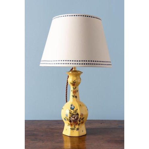 A pair of early 19th-century french faience vases from moustiers, converted to table lamps. They feature a classic...