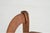 A small antique French Provincial child's armchair in fruitwood with a warm, mellow patina, woven rush seat, gently arched...