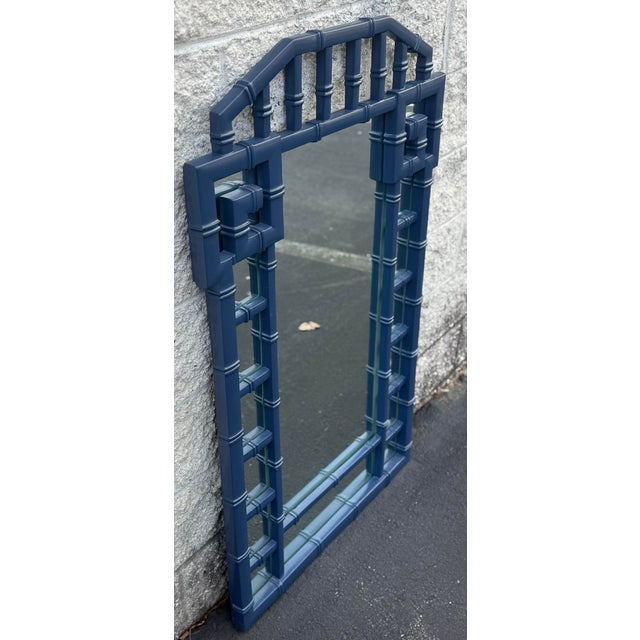 Beautiful Hollywood regency mirror newly lacquered in Hale Navy. Features Greek key detail and faux bamboo motif. Piece...