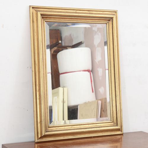 This elegant gilded mirror, dating back to the mid-20th century, is a refined example of a classic antique-style...