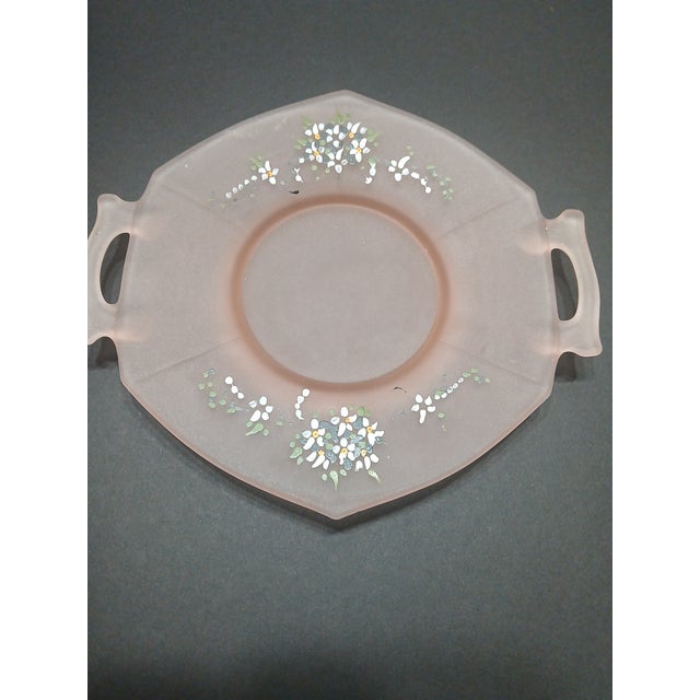This product is a beautifully hand-painted frosted pink octagon plate from the 1970s, featuring a delicate flower pattern....