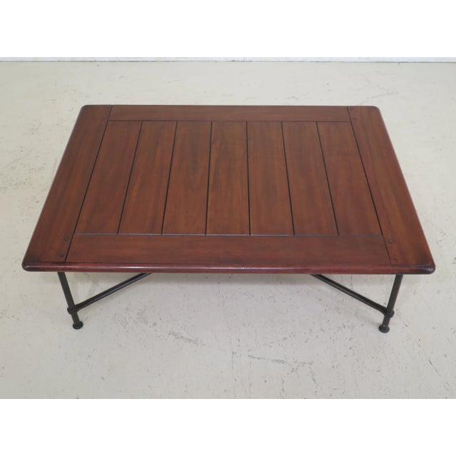 Large cherry top iron base coffee table. Features light factory distressing, high quality construction and heavy IRON base.
