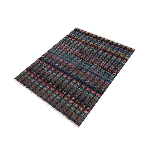 Elevate your interior with this hand-knotted high-low wool area rug, designed to bring depth and dimension to any room....