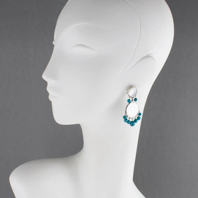 These somptuous Christian Dior Paris clip-on earrings feature a dangling geometric shape with a silvered metal framing...