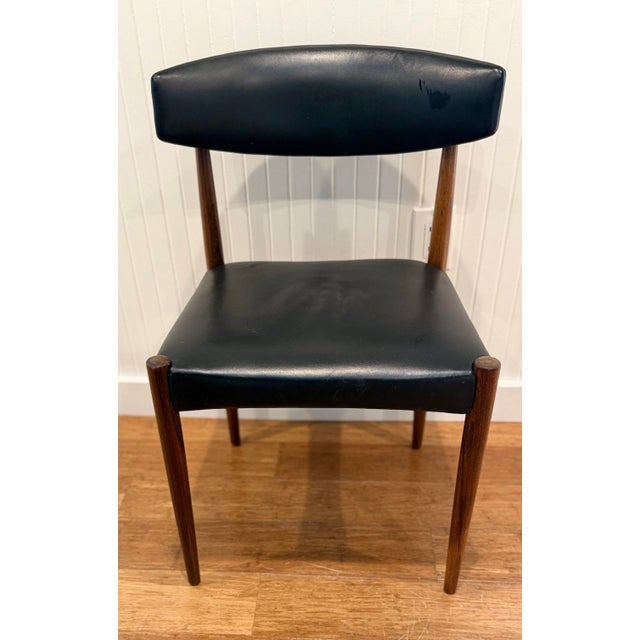 Sculptural set of four Scandinavian Modern dining chairs, circa 1960s. Featuring solid wood frames with tapered legs,...