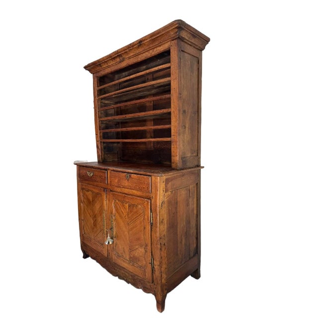 Antique French Oak Vaisselier in good condition. This large buffet has a shelf cabinet which is resting on the lower...