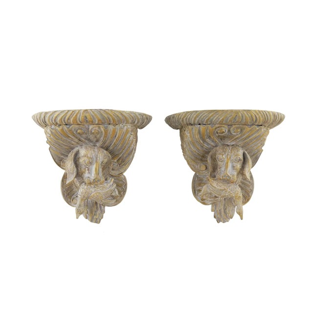 A pair of vintage wooden hand-carved gold dog head wall brackets, the dog holds a fish in its mouth, and the carved lines...