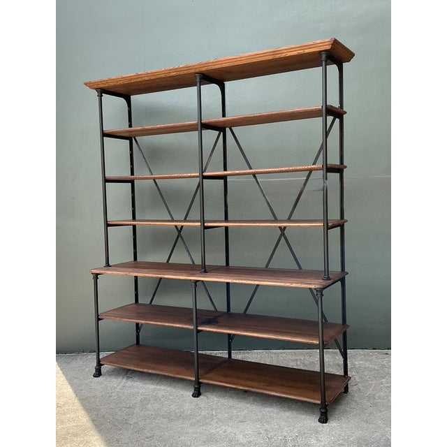 This vintage French industrial bookshelf pairs solid plank wood shelving with a black metal frame for a striking blend of...