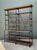 This vintage French industrial bookshelf pairs solid plank wood shelving with a black metal frame for a striking blend of...