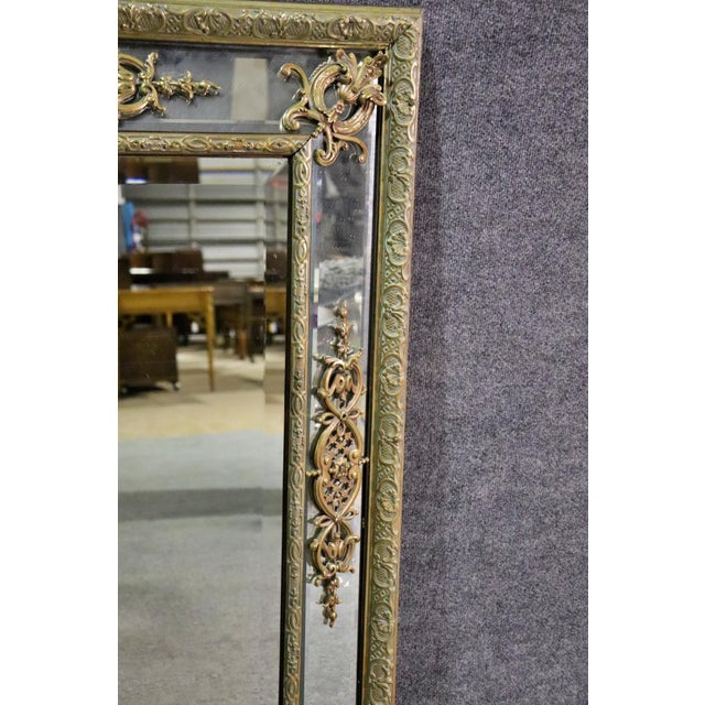 Turn of the century Neoclassical Bronze wall mirror. Bronze frame with beveled glass mirror Dimensions:. 42 5/8" h x 35...